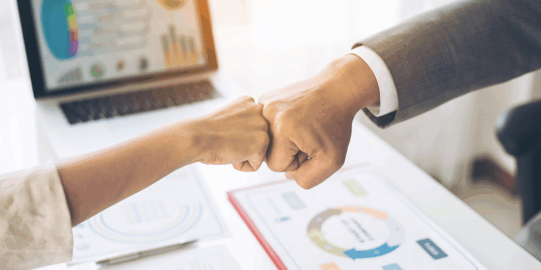 Business owner and advisor working on financial strategy in modern office environment